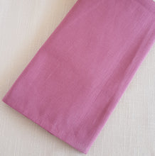 Load image into Gallery viewer, Raspberry  pink napkin on a textured beige background.