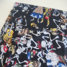 Load image into Gallery viewer, Fabric with colorful skeleton designs on a black background