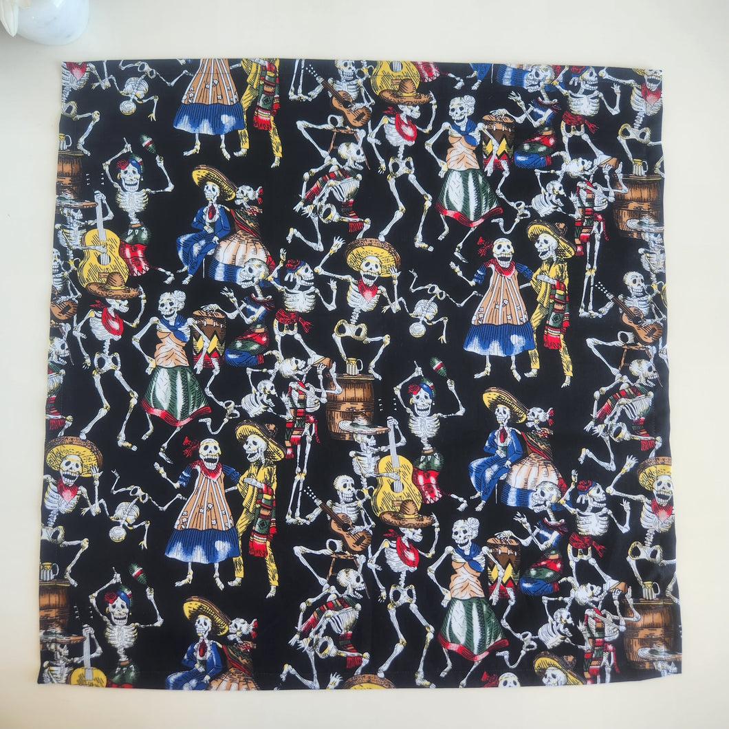 Fabric with colorful skeleton designs on a black background