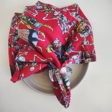 Load image into Gallery viewer, Red fabric with skeleton and card design on a white plate