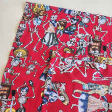 Load image into Gallery viewer, Red fabric with colourful skeleton print on a white background