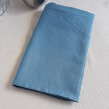 Load image into Gallery viewer, Dusty marine blue linen–cotton dinner napkin with 2cm hem and mitered corners, neatly folded for a table setting
