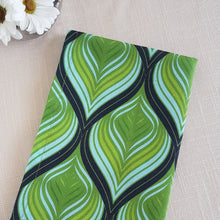 Load image into Gallery viewer, Green, aqua, and black swirl design on a linen–cotton cocktail napkin with crisp, tailored edges