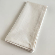 Load image into Gallery viewer, Folded cream fabric napkin on a light gray background