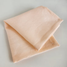 Load image into Gallery viewer, peach coloured napkin folded in 4