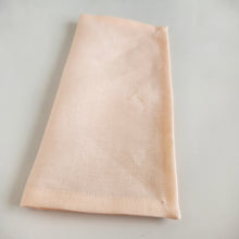 Load image into Gallery viewer, Folded peach coloured fabric on a light background