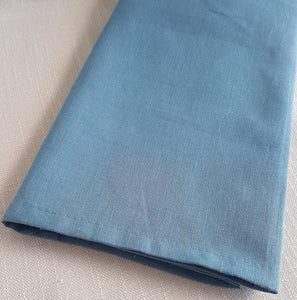 Dusty marine blue linen–cotton dinner napkin with 2cm hem and mitered corners, neatly folded for a table setting