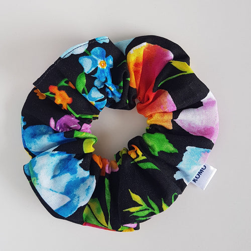 Bright tropical flower print on black - mix of yellow, blue, pink, green and orange flowers. Cotton hair scrunchie.